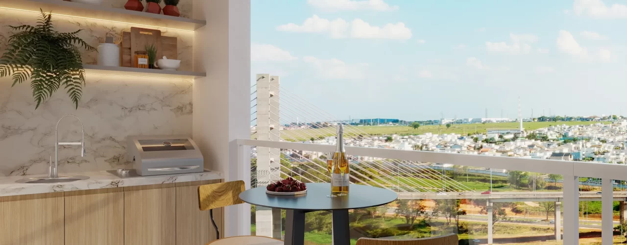 Varanda gourmet de apartamento com bancada em mármore, prateleiras iluminadas e mesa bistrô com duas cadeiras, oferecendo vista para ponte estaiada e área verde da cidade.